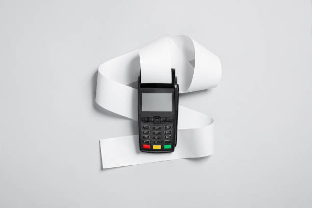 Payment terminal with thermal paper for receipt on light grey background, top view