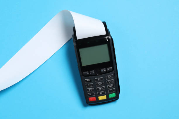 istock Payment terminal with thermal paper for receipt on light blue background, top view 1835869765