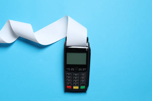istock Payment terminal with thermal paper for receipt on light blue background, top view 1835869797