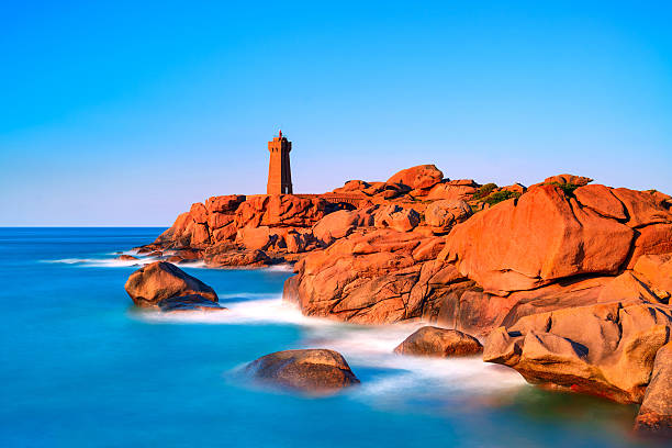 istock Ploumanach lighthouse sunset in pink granite coast, Brittany, Fr 183587049