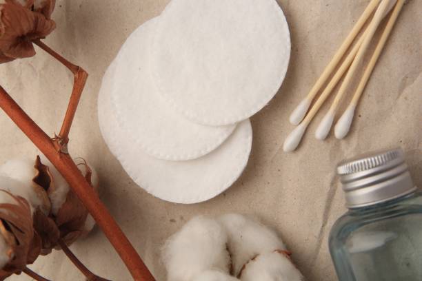 istock Flat lay composition with makeup remover and cotton flowers on crumpled paper 1835878335