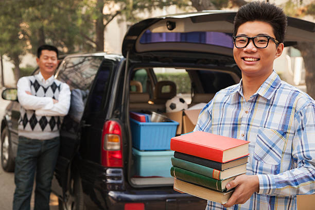 istock Boy unpacking car for college 183588130
