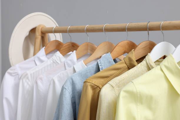 istock Rack with different stylish shirts against grey background, closeup. Organizing clothes 1835885304