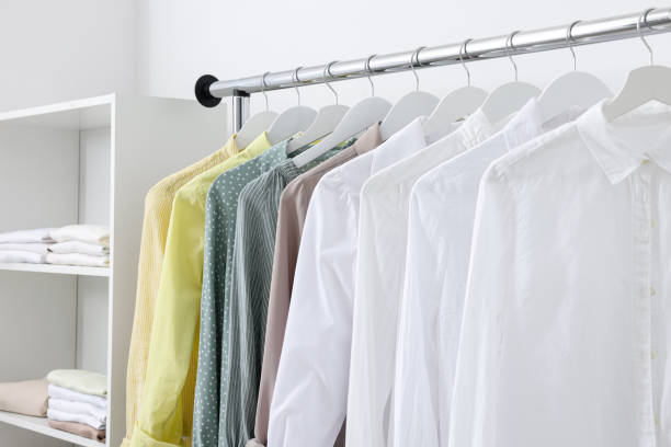istock Wardrobe organization. Rack with different stylish clothes near white wall, closeup 1835888572