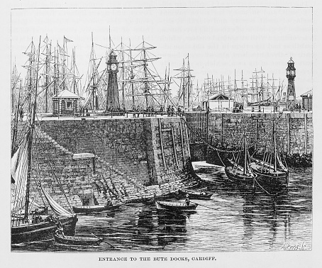 Illustration from Harper's New Monthly Magazine Vol. LIV December 1876 to May 1877: An image of the stone Bute Docks in Cardiff, Wales with small sailing ships in the foreground and a forest of tall masts in the background.