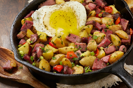 Corned Beef Hash with a Fried Egg, Potatoes, Onions and Red Pepper