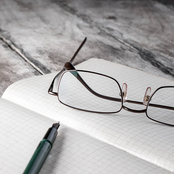 istock Old book with glasses lay on a table. 183591750