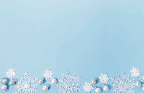 istock Blue Christmas holiday composition. Festive creative white pattern, xmas decor holiday ball with snowflakes on blue background. 1835931028