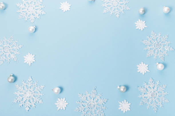 istock Blue Christmas holiday composition. Festive creative white pattern, xmas decor holiday ball with snowflakes on blue background. 1835931037