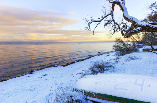 Baltic Sea coast in winter, fishing boat with an inscription on the snow 2024. Latvia, Europe