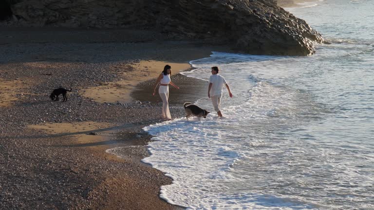 Young couple on the beach at sunrise