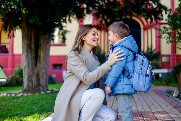 istock Mother stands by son on first day of elementary school 1835936810