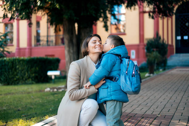 istock Mother's kiss before son steps into school 1835936820