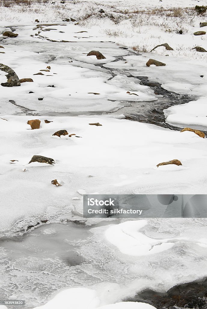 Stream of water runs among ice and snow in Jotunheimen Stream of water runs among ice, snow and rocks in Jotunheimen National Park, Norway Beauty In Nature Stock Photo