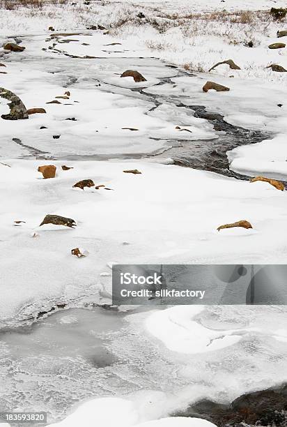 Stream Of Water Runs Among Ice And Snow In Jotunheimen Stock Photo - Download Image Now