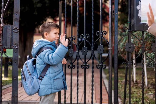 istock Mother observes as he walks into the school 1835943650