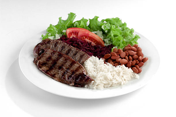 Typical dish of Brazil, rice and beans This is the most common dish in Brazil, rice, beans, steak and tomato salad with lettuce. rice food staple photos stock pictures, royalty-free photos & images