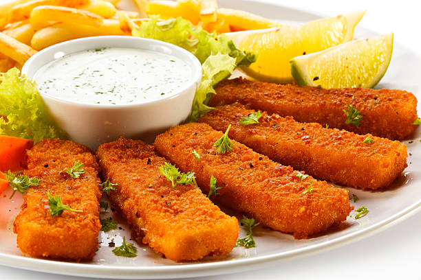 Fried fish fingers, French fries and vegetables Fish dish fish stick stock pictures, royalty-free photos & images