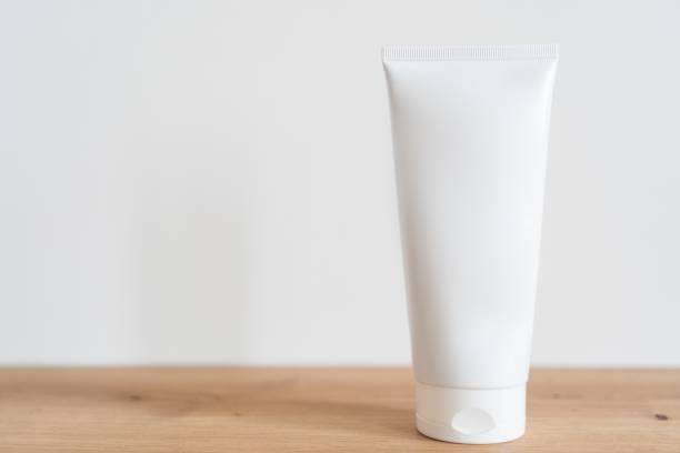 istock White tube cream mockup on a wooden table. 1835975541