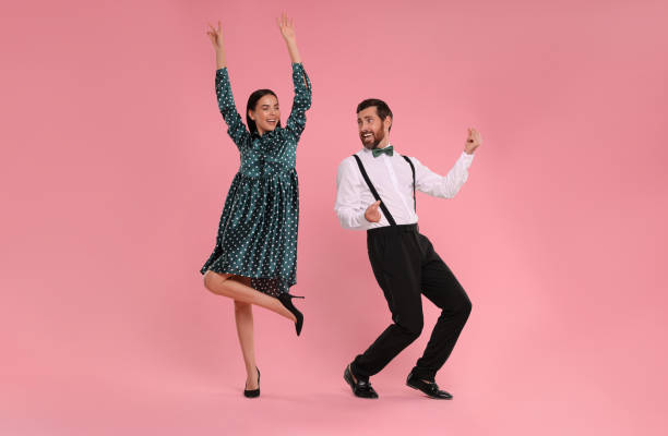 분홍색 배경에서 함께 춤을 추는 행복한 커플 - polka dancing 뉴스 사진 이미지