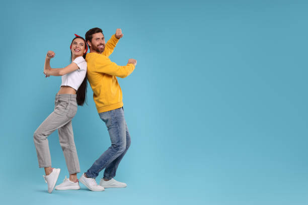 istock Happy couple dancing together on light blue background, space for text 1835981989