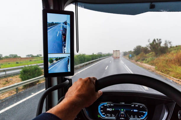 Rearview mirror with cameras in a truck, screen inside the vehicle where the driver can see the back of the trailer on a rainy day. Rearview mirror with cameras in a truck, screen inside the vehicle where the driver can see the back of the trailer. truck rain stock pictures, royalty-free photos & images