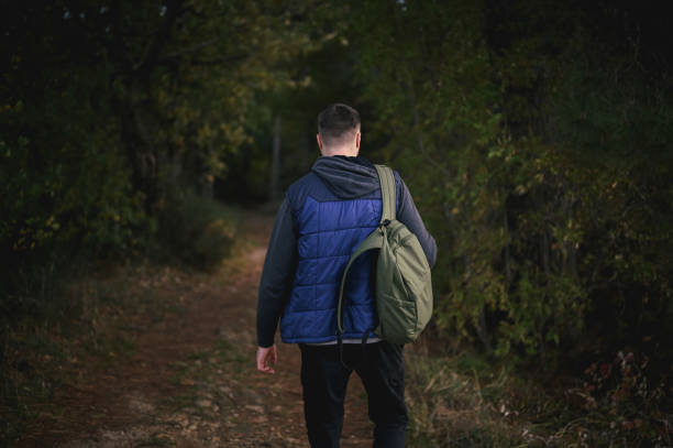 istock rear view of a man exploring woodland. 1835986044