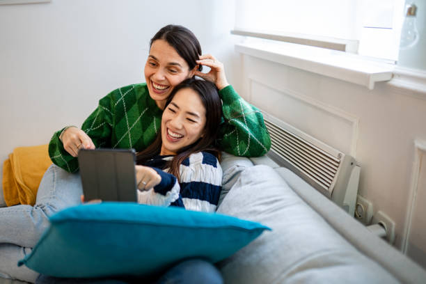 istock Two beautiful women using their digital tablet on the couch 1836043065