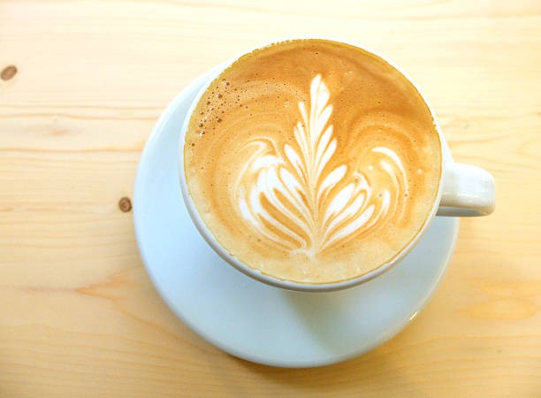 istock Latte art coffee on wooden table 183604916