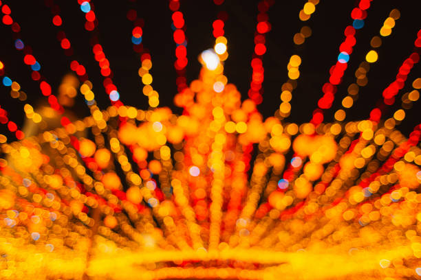 Abstract Background  Kyiv, Ukraine January 2, 2022, Defocused Illuminated Gold Christmas Tree on Sophia Square in Kyiv. Fairy-tale decorated tree and Christmas market on Sophia Square, Scenic winter evening