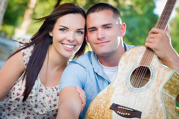 istock Mixed Race Couple Portrait with Guitar in Park 183607448