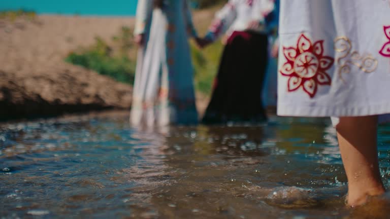 East Slavic celebration of summer solstice, closeup view of legs in river water, 4K, Prores