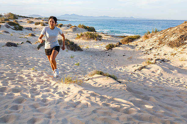 Young Indian female jogging outdoors by the sea