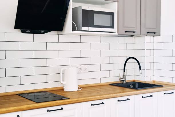 istock White cabinets with wooden counter of modern kitchen 1836109969