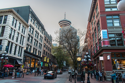 Vancouver, CANADA - Sep 29 2023 : Cityscape of Gastown in cloudy day. Famous steam-powered clock at Gastown (Gastown Steam Clock) seen in image.