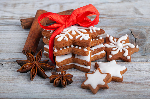 Christmas gingerbread cookie stars on wooden table.