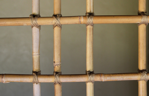 Close up abstract background of a brown wooden bamboo trellis