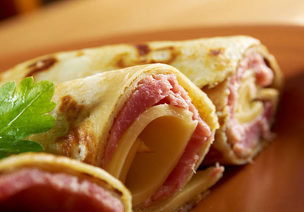 rolled pancakes stuffed ham and cheese. stock photo