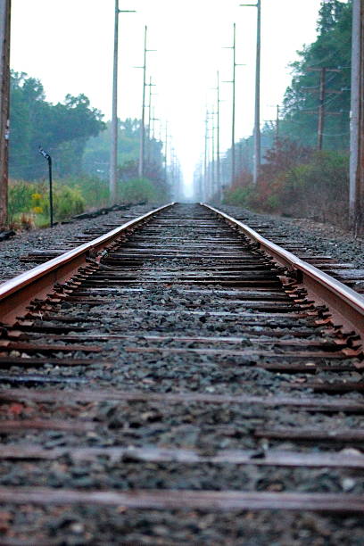 Railroad Before Dusk Fog Down the Tracks stock photo
