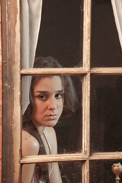 istock Sad Young Adult Behind A Window 183631698