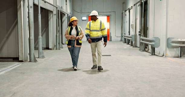 istock Engineer woman, man and walking in warehouse for planning discussion for manufacturing, logistics or industry. Teamwork, thinking and brainstorming for vision, supply chain and commerce in factory 1836330621