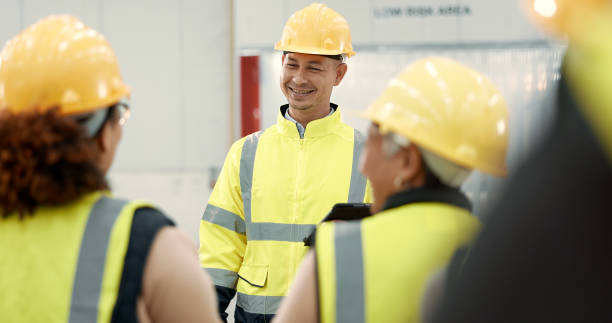 istock Construction site, engineering and people in discussion for planning, maintenance and renovation in building. Architecture, meeting and men and women for inspection, property development and project 1836330635