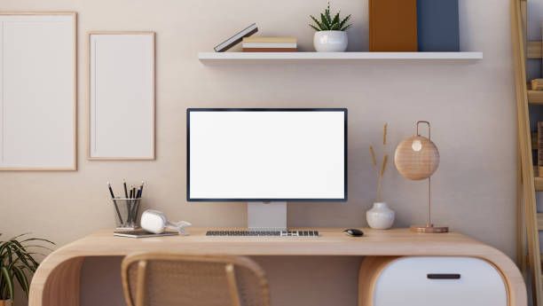 istock A white-screen PC computer mockup and accessories on a modern, minimalist wooden desk. Home office 1836357610