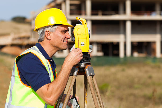 istock senior land surveyor working with theodolite 183636404