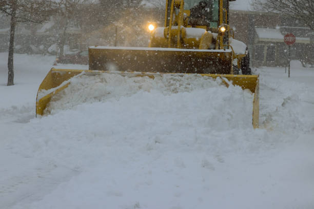 during heavy snowfall, snow is removed from parking lot by a snowplow truck - snowplow snow parking lot pick up truck imagens e fotografias de stock