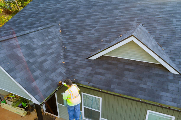 istock A worker cleans clogged roof gutter drain from dirt debris, as well as fallen leaves that have fallen 1836380193