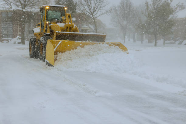 in midst of heavy snowstorm, snowplow truck removes snow from a car parking lot - snowplow snow parking lot pick up truck imagens e fotografias de stock