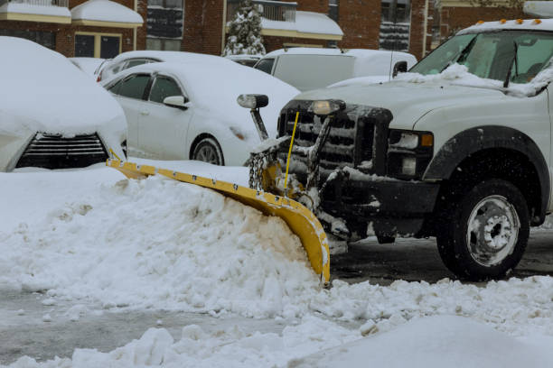 during a heavy snowfall, snowplow truck removes snow from parking lot - snowplow snow parking lot pick up truck imagens e fotografias de stock