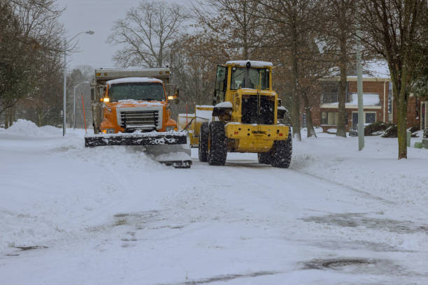 snowplow truck removes snow during heavy snowfall snowstorm from a car parking lot near residential area - snowplow snow parking lot pick up truck imagens e fotografias de stock