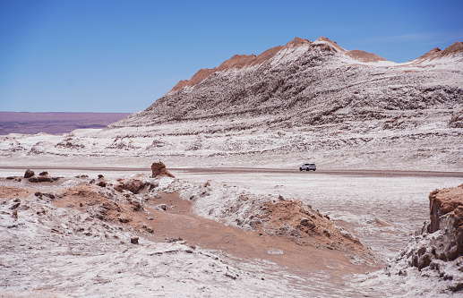 Vehicle in the distance crossing the Atacama desert.